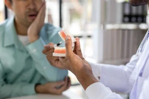 Doctor discussing dentures with worried patient