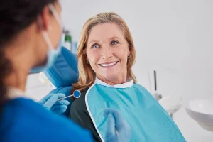Smiling senior woman looking at dentist